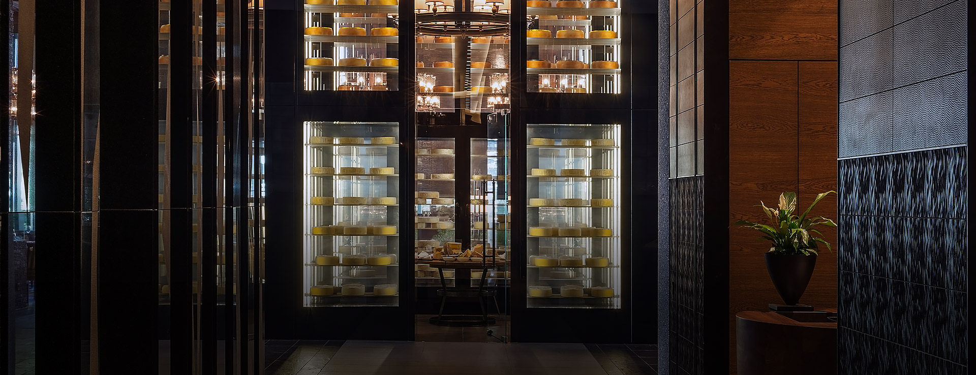 Numerous cheeses are stored in a metre-high, glass humidor