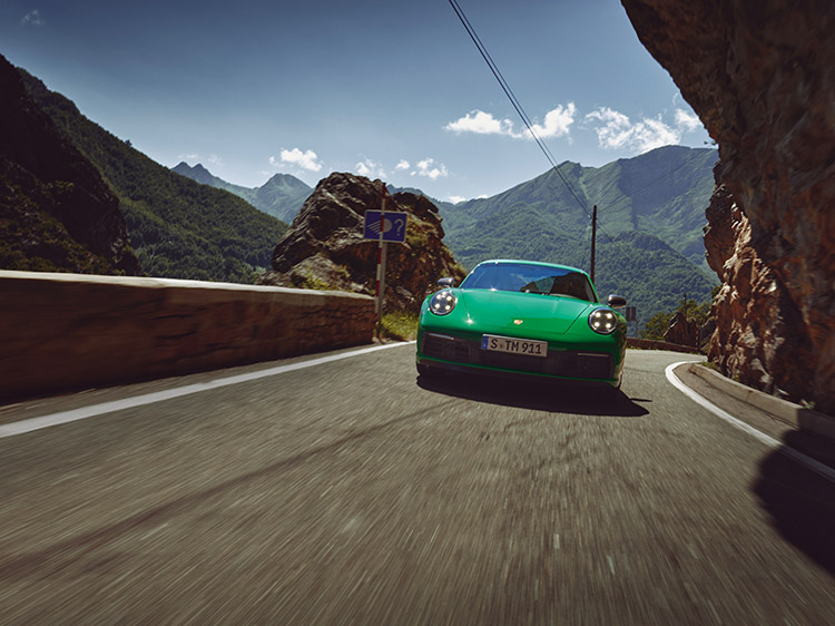 Python Green Porsche 911 Carrera T driving on mountain road