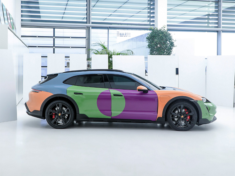Pastel colour-blocked electric Porsche art car inside white studio