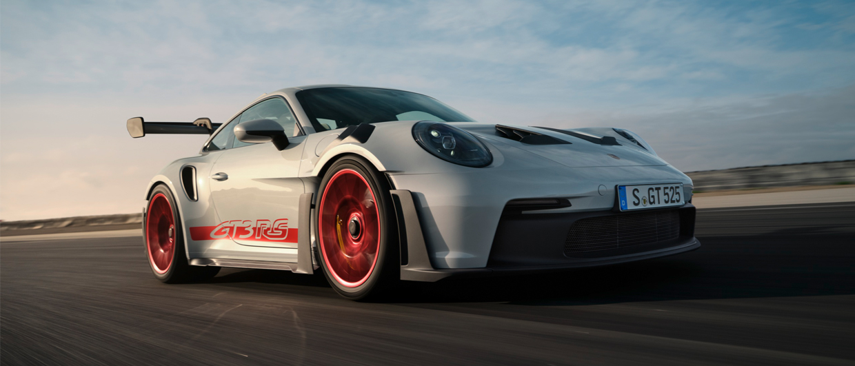 Porsche 911 GTS RS racing around bend of racetrack