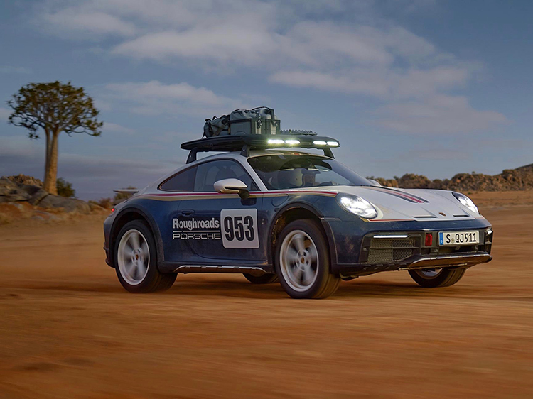 Porsche 911 Dakar driving across rugged terrain