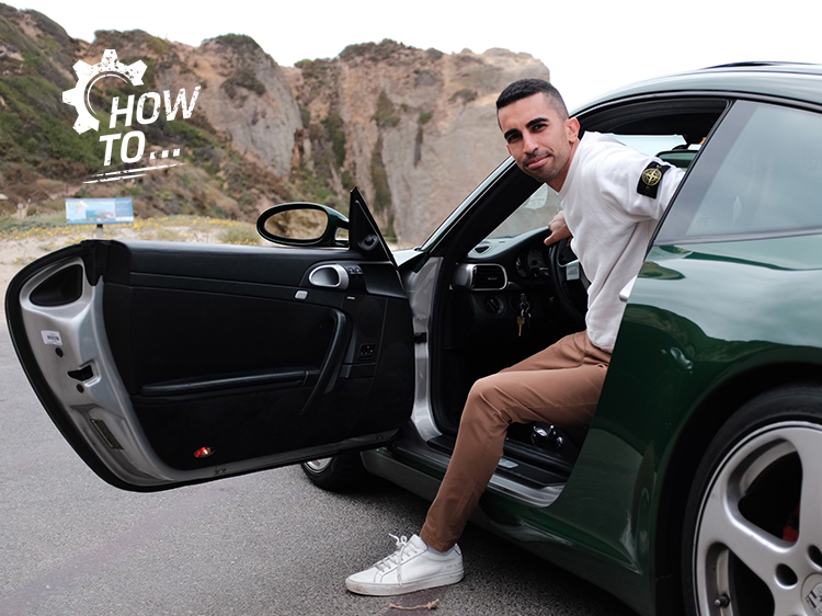 Man exits cockpit of dark green Porsche 911 (type 997.1)