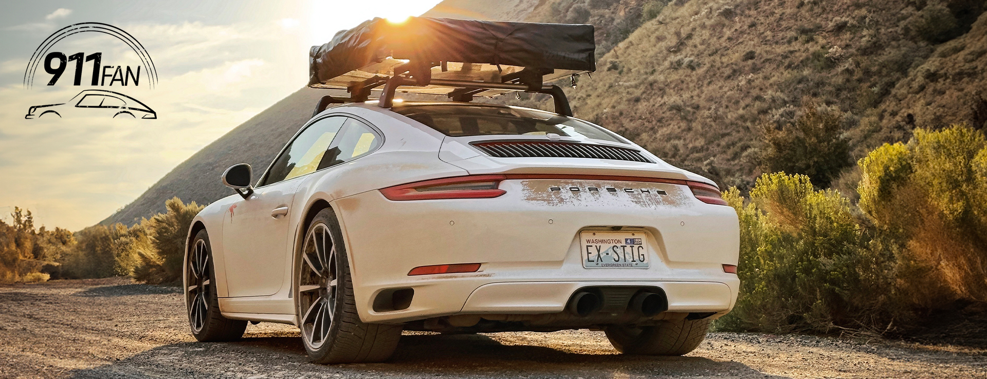 Porsche 911 Carrera 4 with roof tent attached at sunset