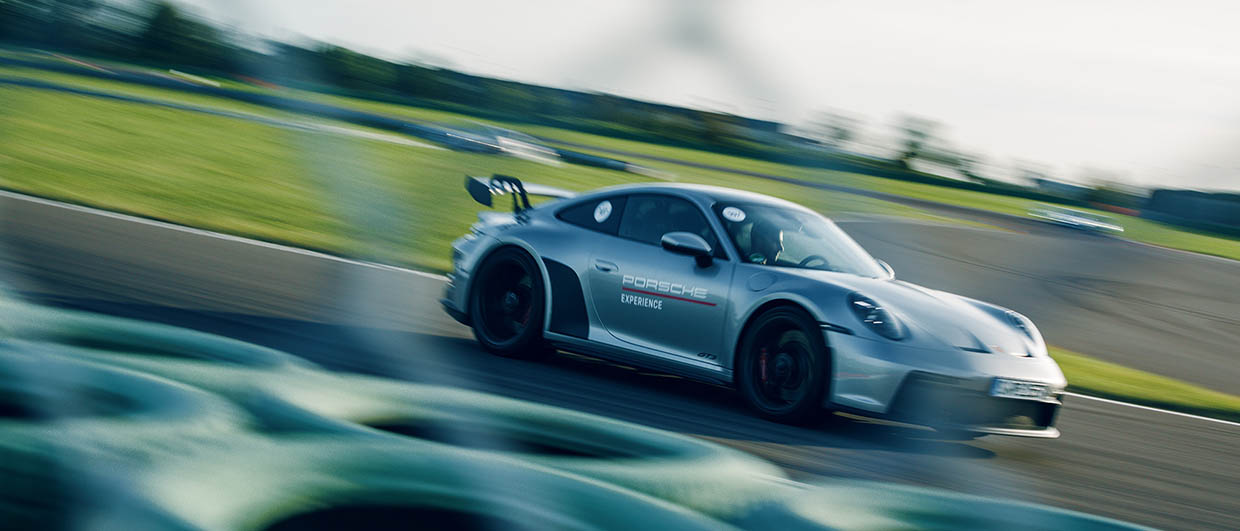 Silver 911 GT3 driving on racetrack