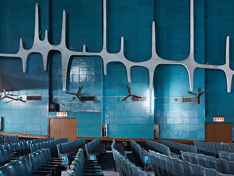 Cinema seating in a blue, tiled interior