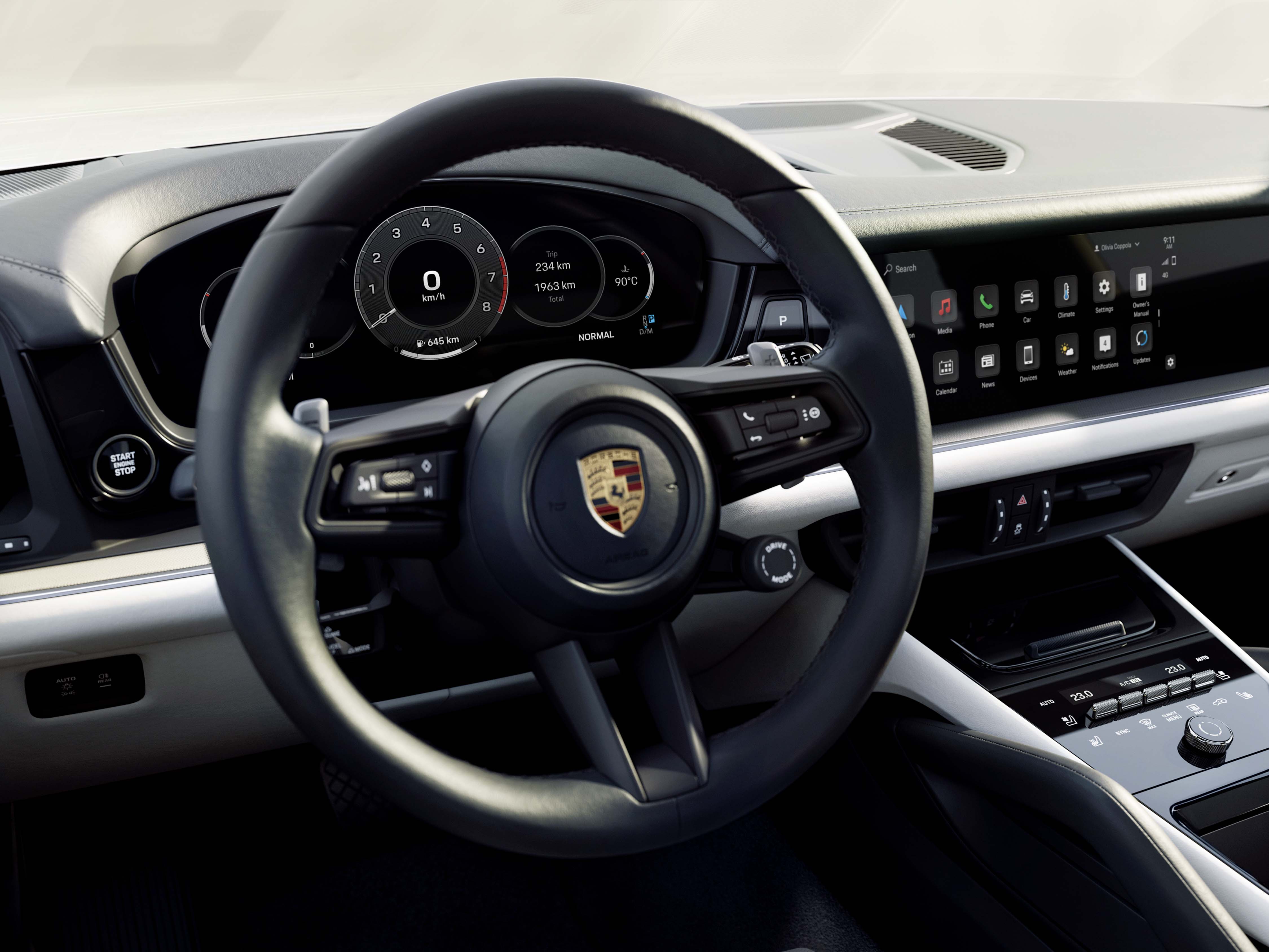 New Porsche Cayenne interior showing steering wheel and driver display