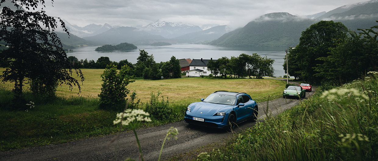 Line of Porsche Taycan Cross Turismo cars in Norwegian landscape