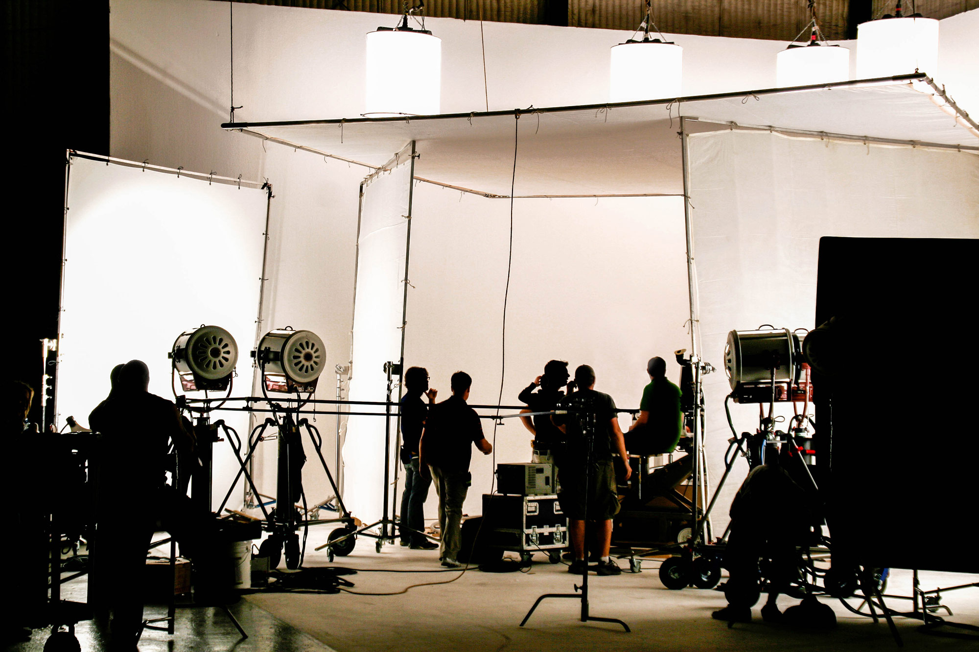Film crew in production hall with camera