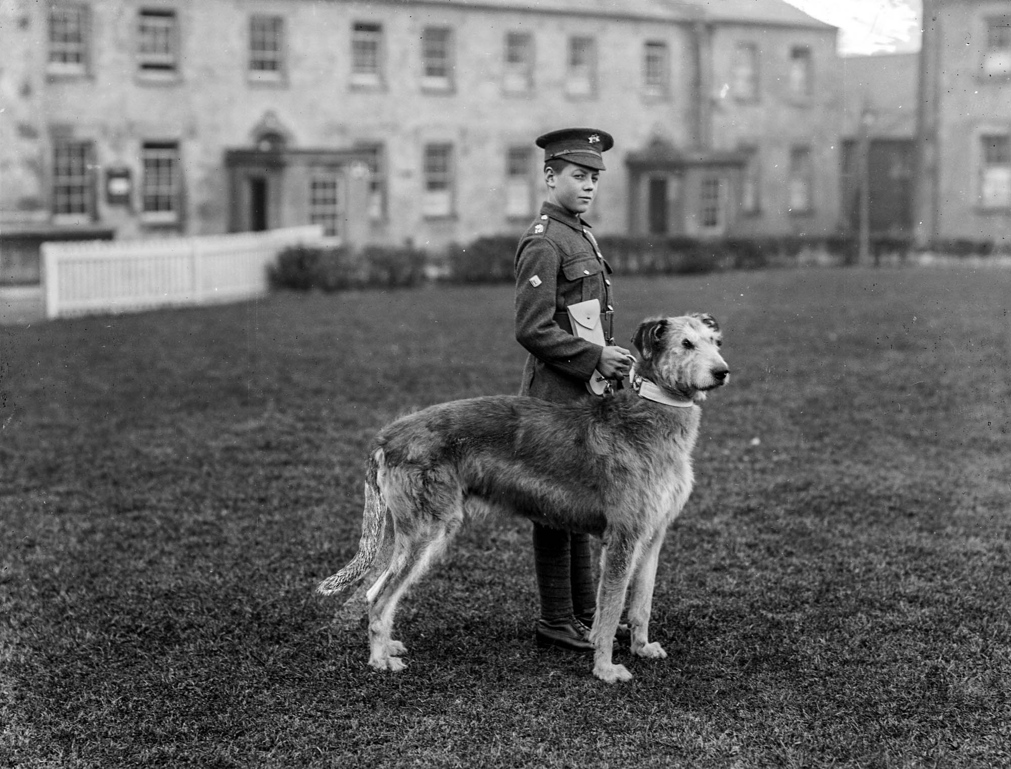 Young soldier in black and white photo with Irish wolfhound