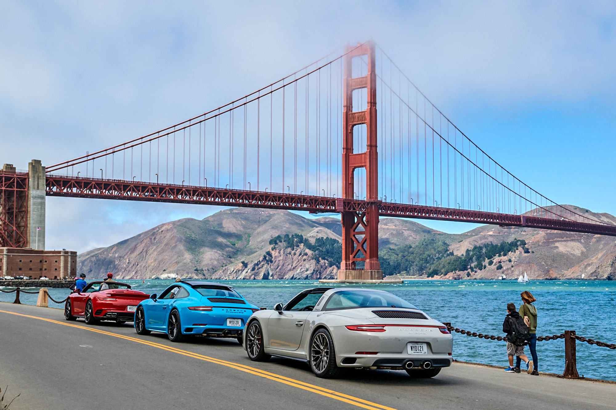 Porsche vehicles approaching the Golden Gate Bridge in San Francisco