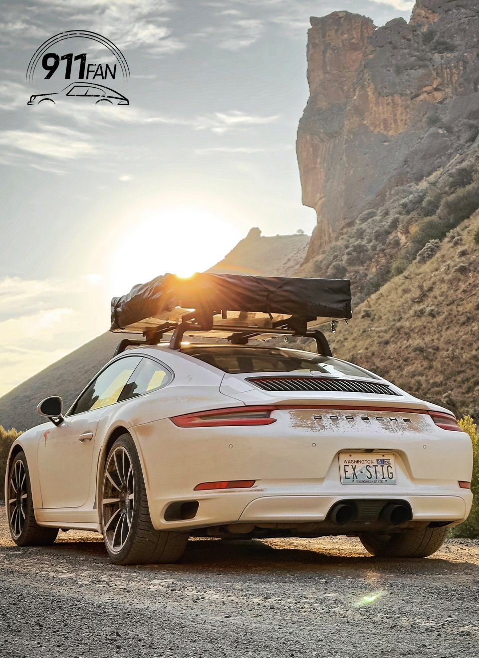 Porsche 911 Carrera 4 with roof tent attached at sunset