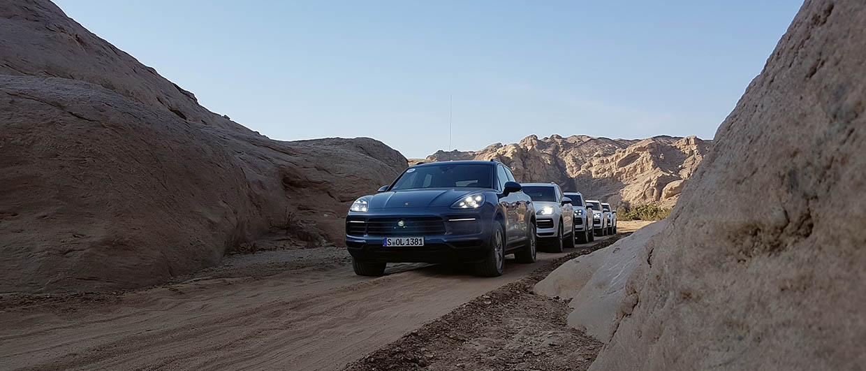 Porsche Cayenne queuing up while driving on rough terrain