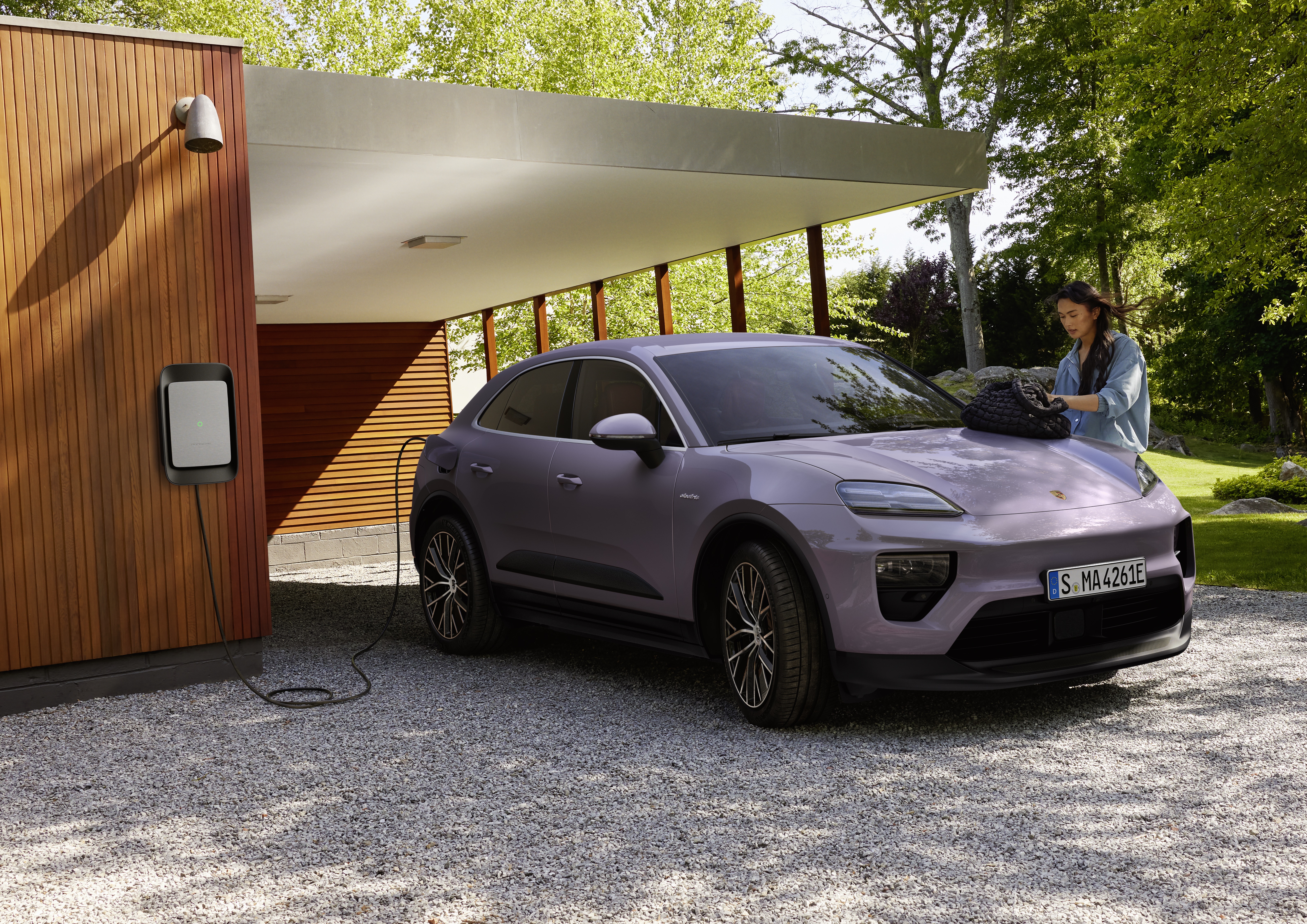 Electric Porsche Macan 4 in Provence colour charging at house