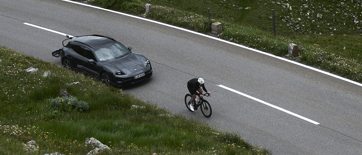 Porsche Taycan Cross Turismo with bike rack corners a bend