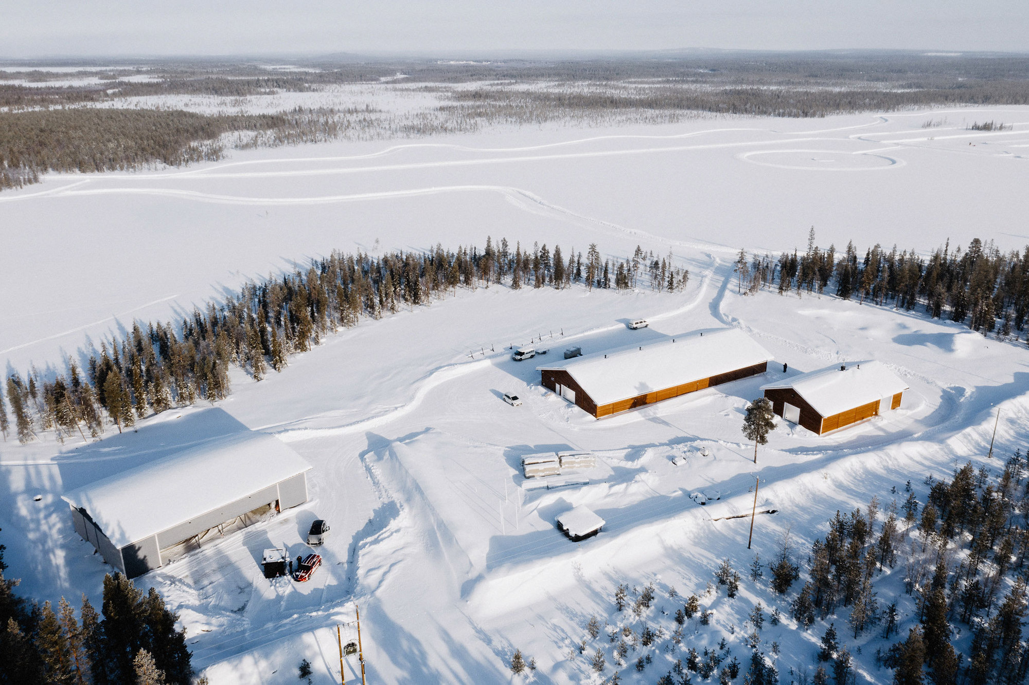 Porsche workshop facilities amid a white, Finnish landscape, from above