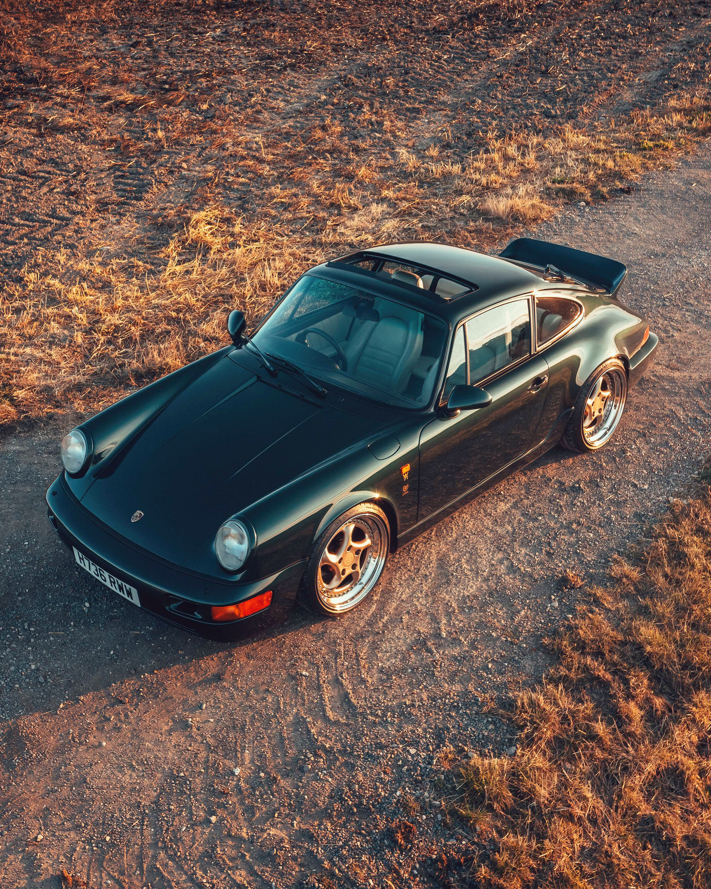 Porsche 911 (964) parked beside a field, photographed from above