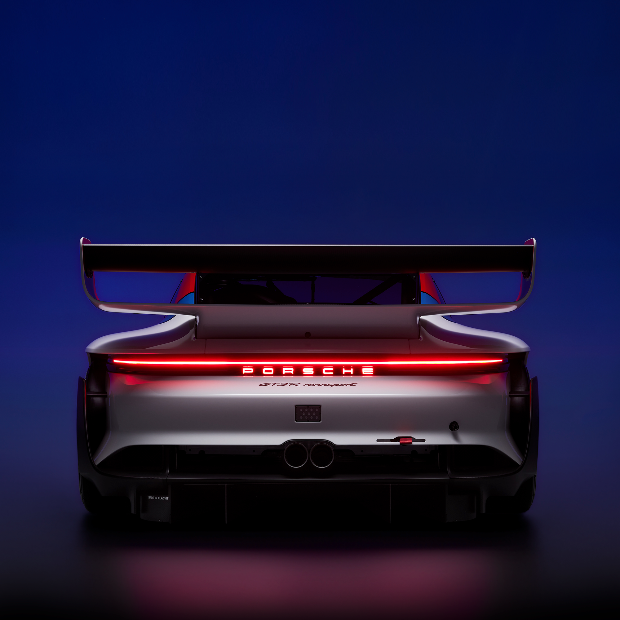 Porsche GT3 R rennsport race car, rear view with illuminated taillights