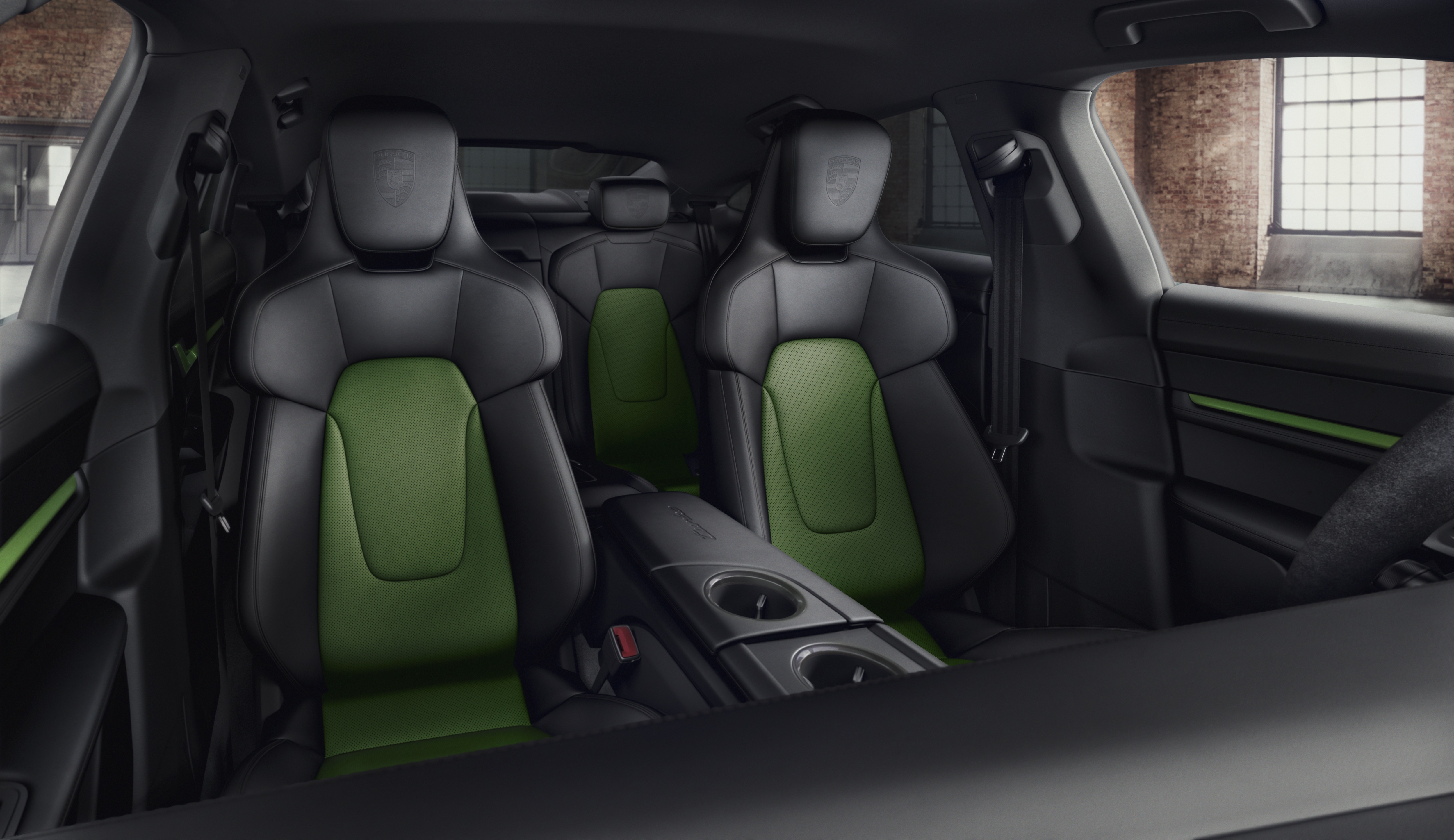 Interior of Taycan with dark grey seats and green inserts