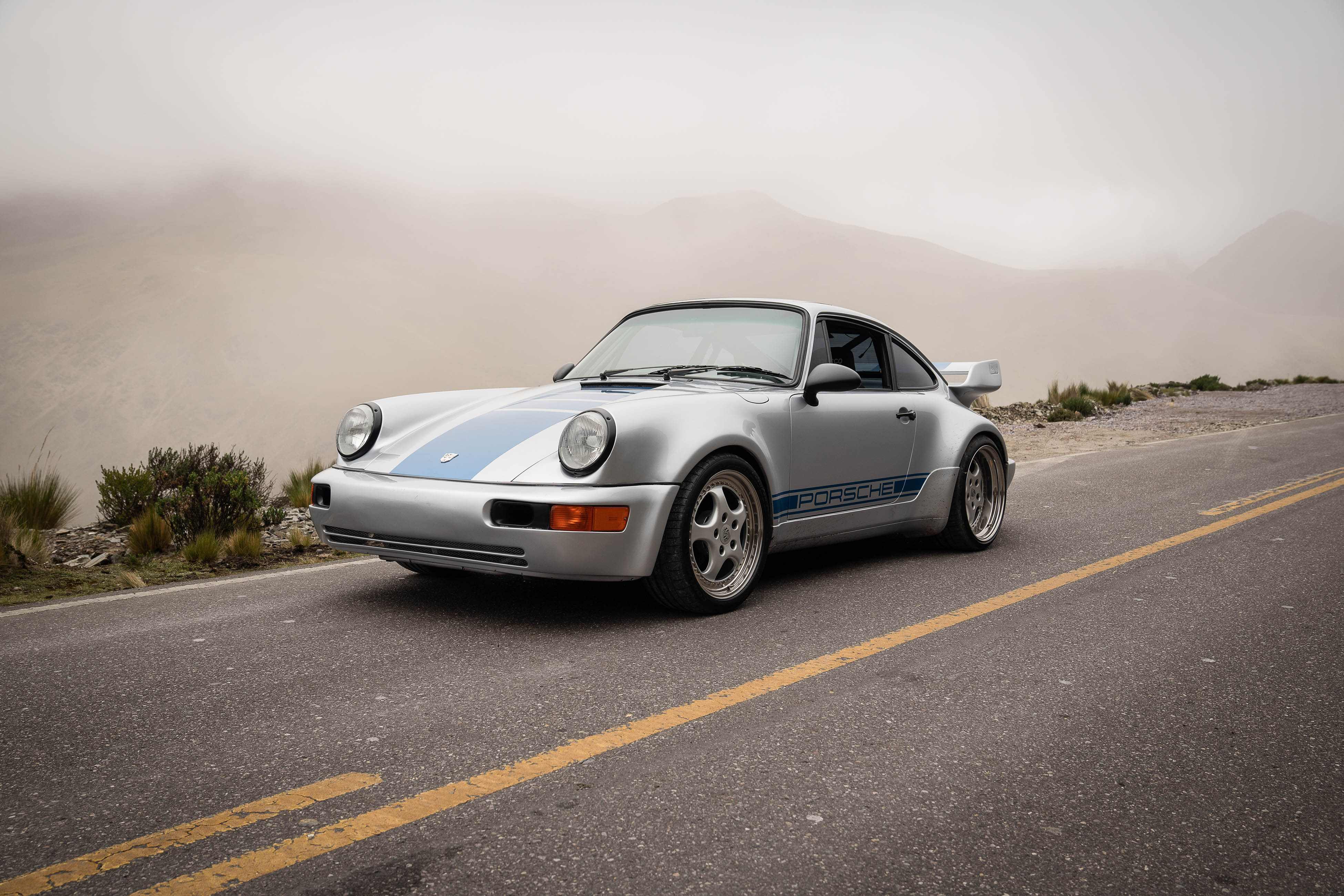 Silver Porsche 911 Carrera RS 3.8 driving on open road