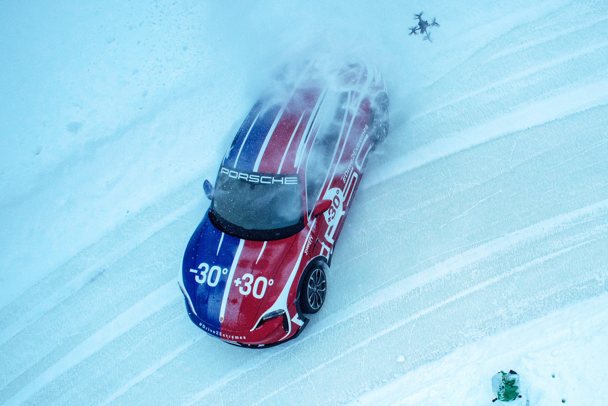 Porsche Taycan Cross Turismo drifts across ice through a bend