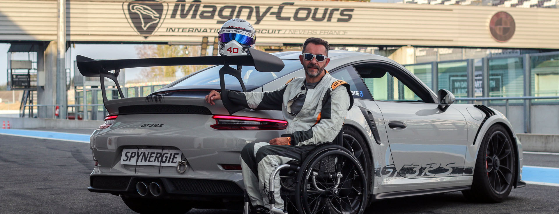 Porsche 911 GT3 RS at Magny-Cours with man in wheelchair