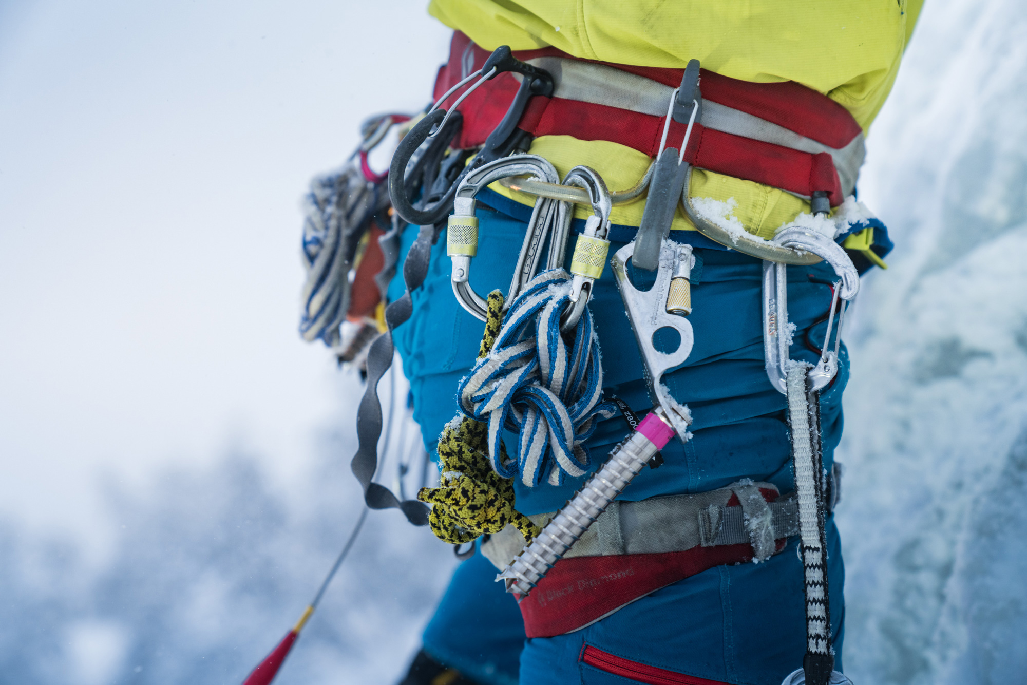 Close-up of ice climber showing hooks and ropes around waist