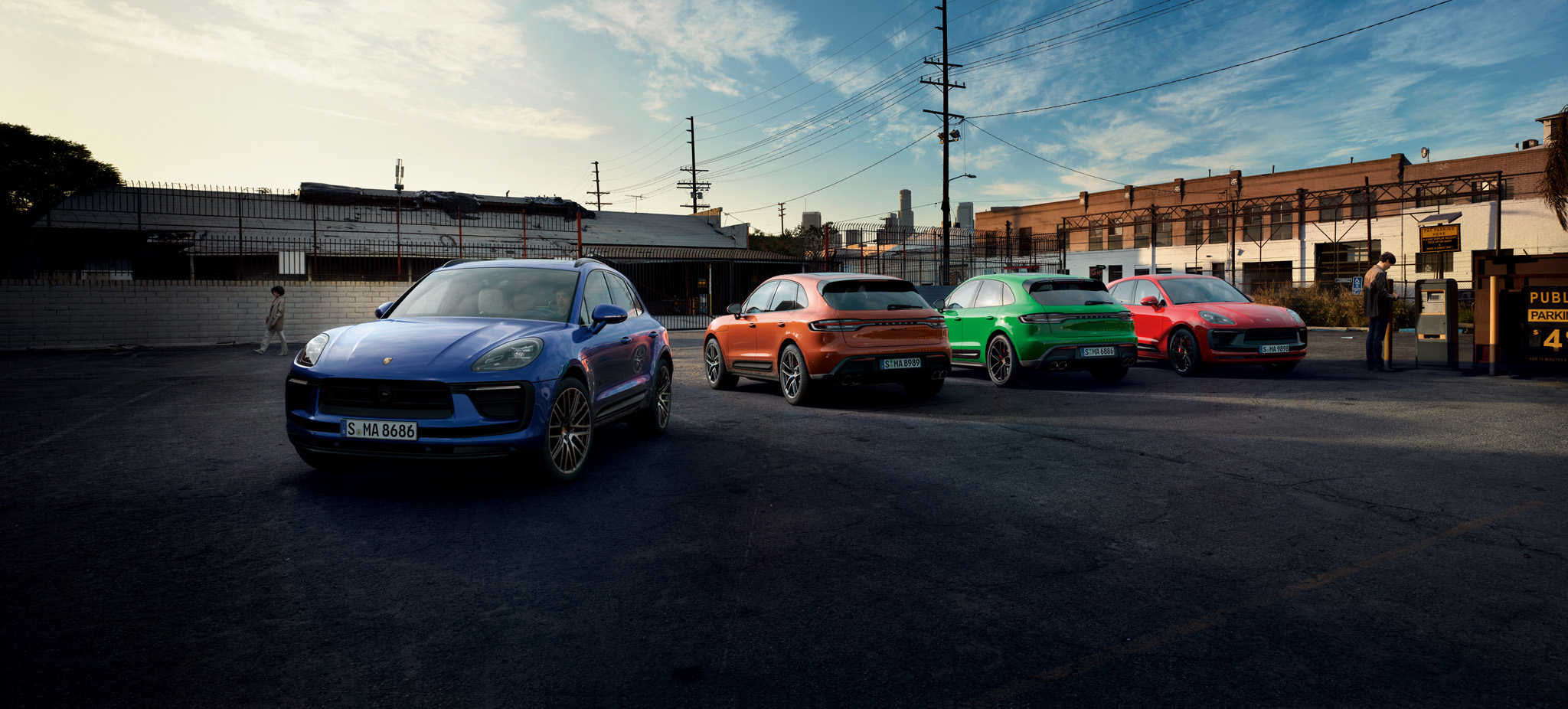 Colourful line-up of the Porsche Macan range in urban location