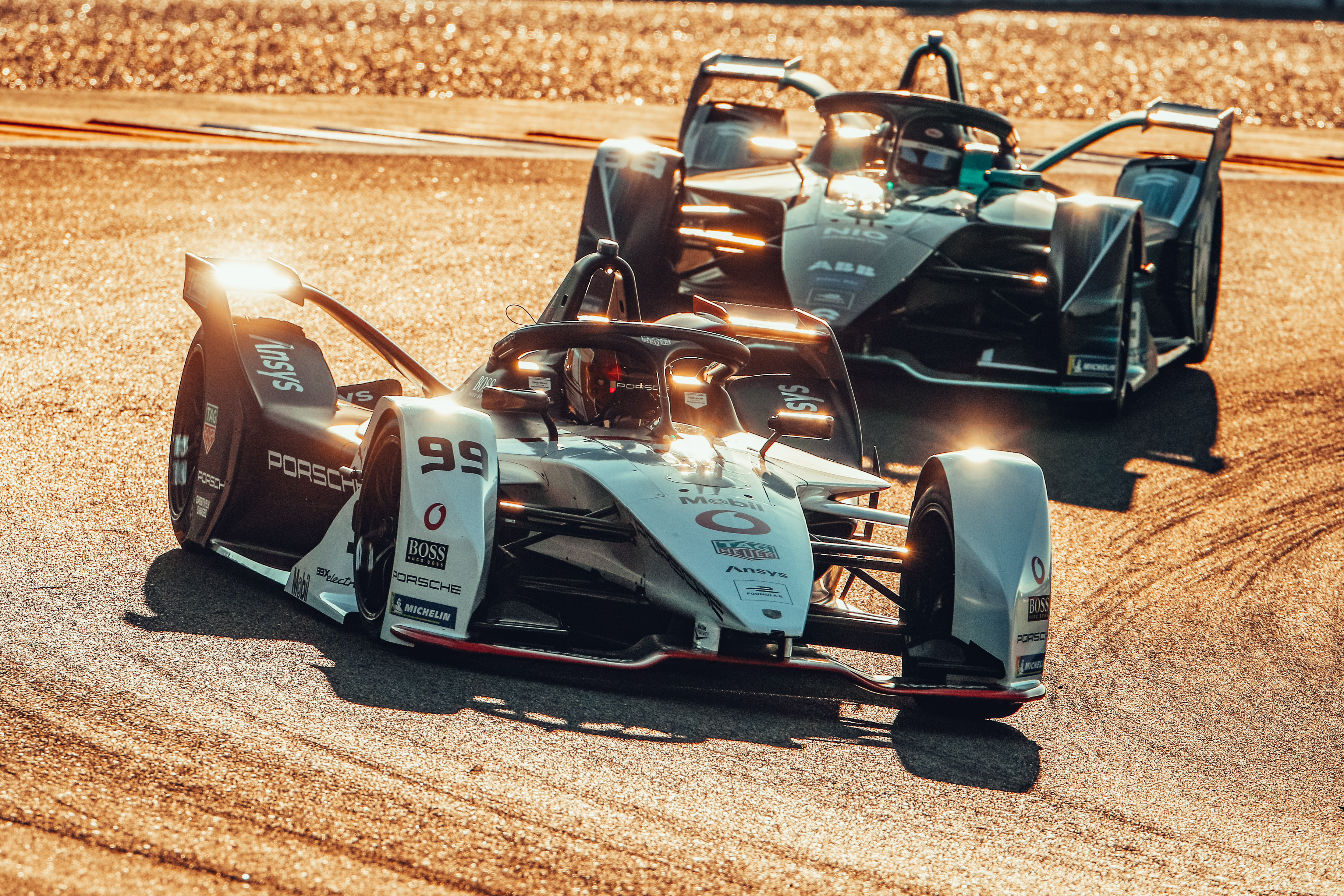 Two Formula E cars battle for supremacy on the track