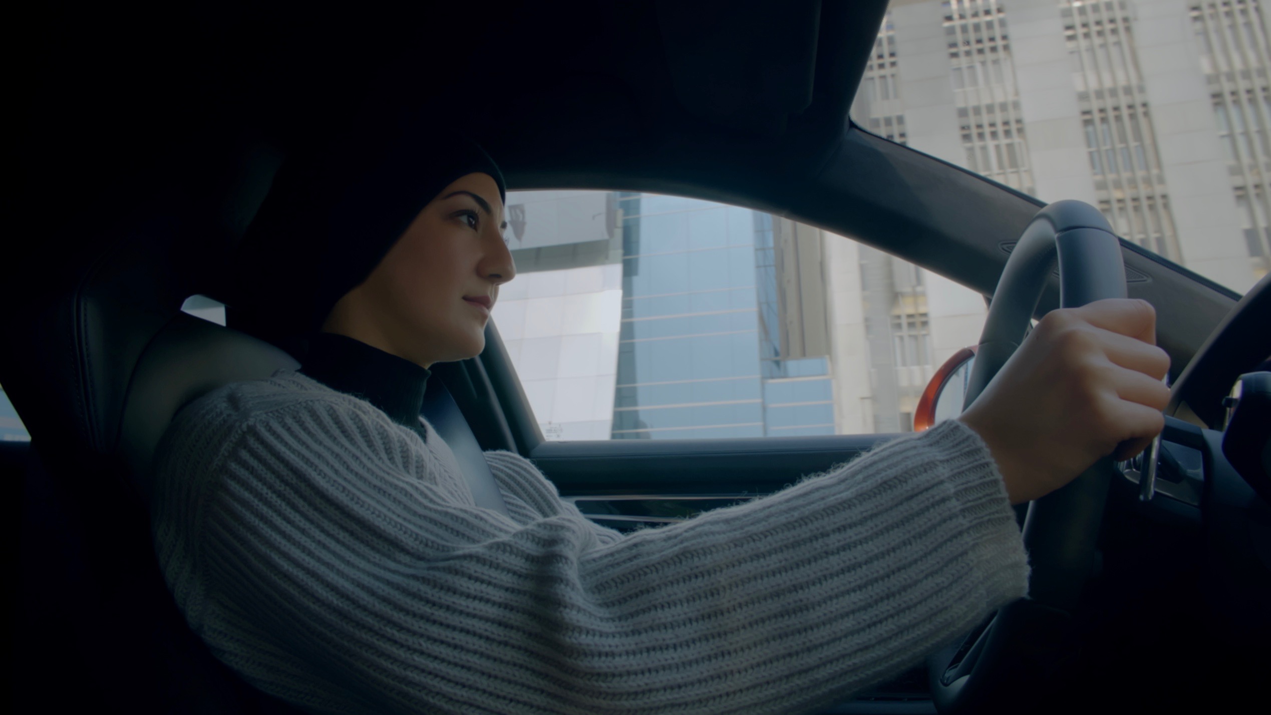 Woman at wheel of Porsche Panamera, taken from inside