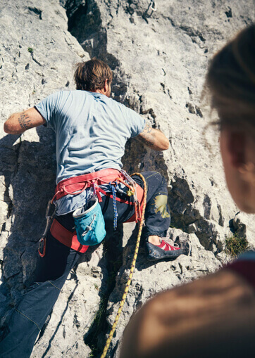 Close-up of climber from behind on rock face