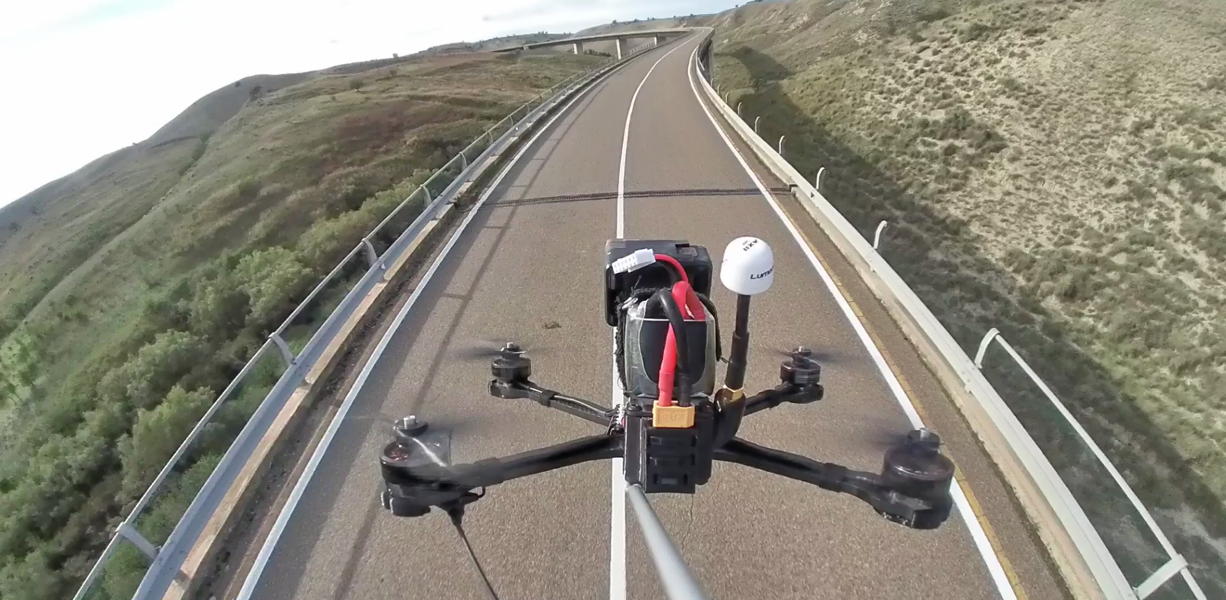 Close-up of drone hovering just above a road