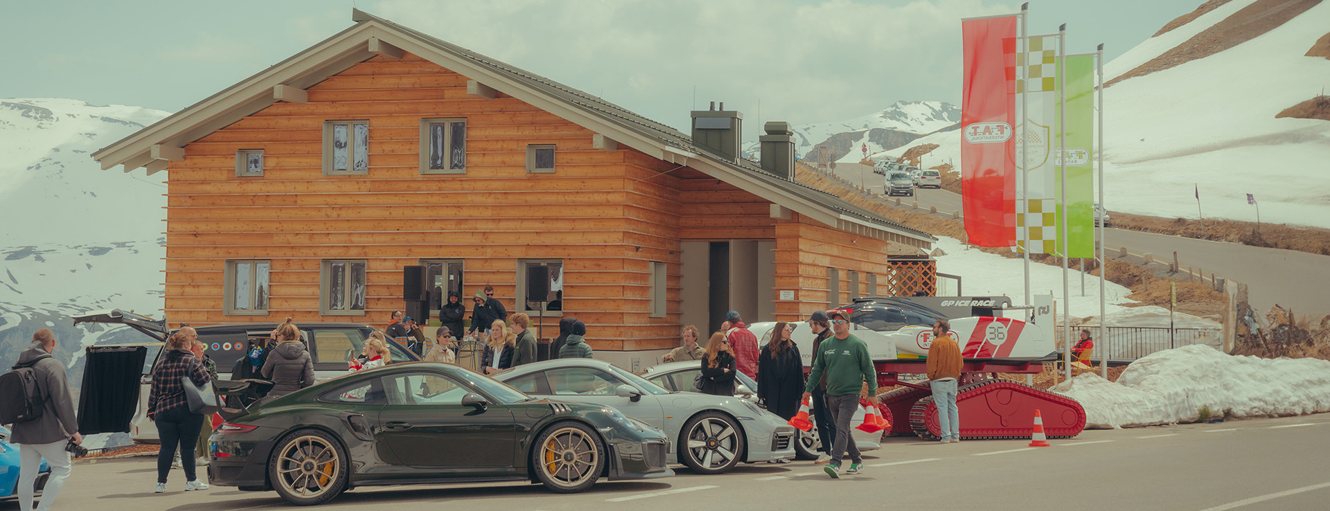 People and Porsche cars outside F.A.T. Mankei, Grossglockner Pass, Austria