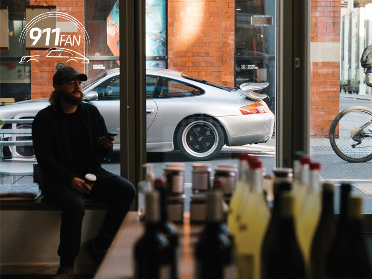 View of Porsche 911 (Type 996) through café window
