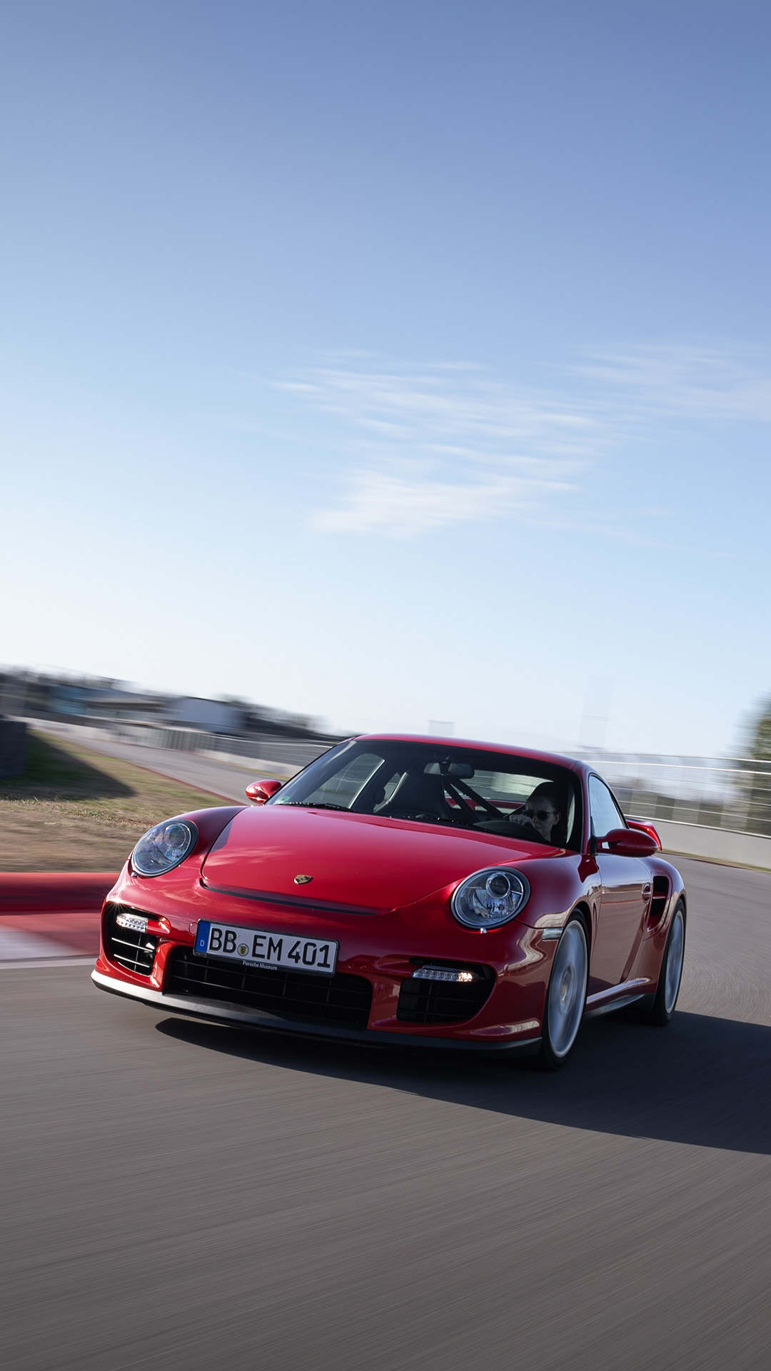 Porsche 911 GT2 type 997 red cornering on racetrack_mobile