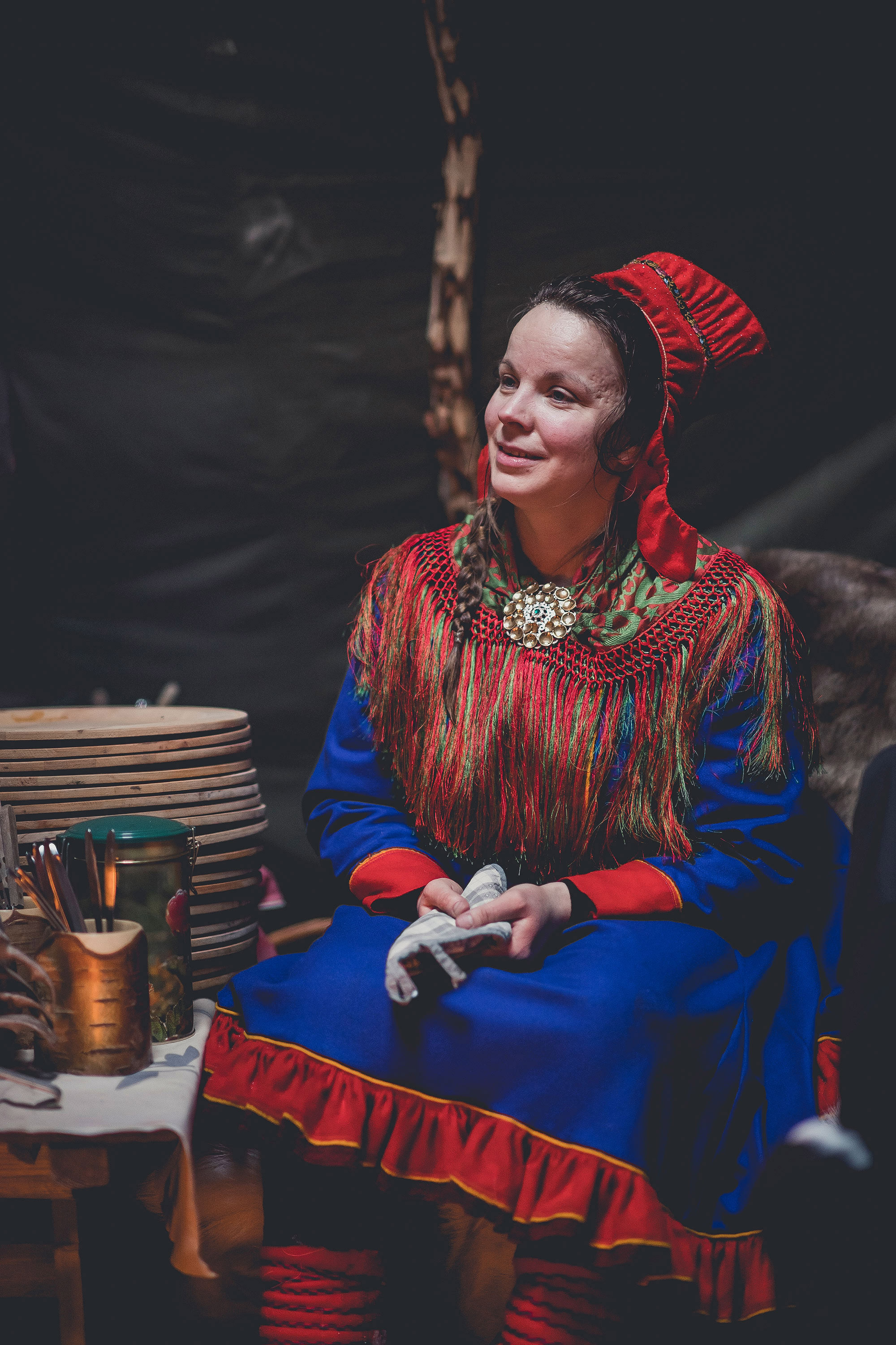 A Sami woman in traditional costume inside her tent