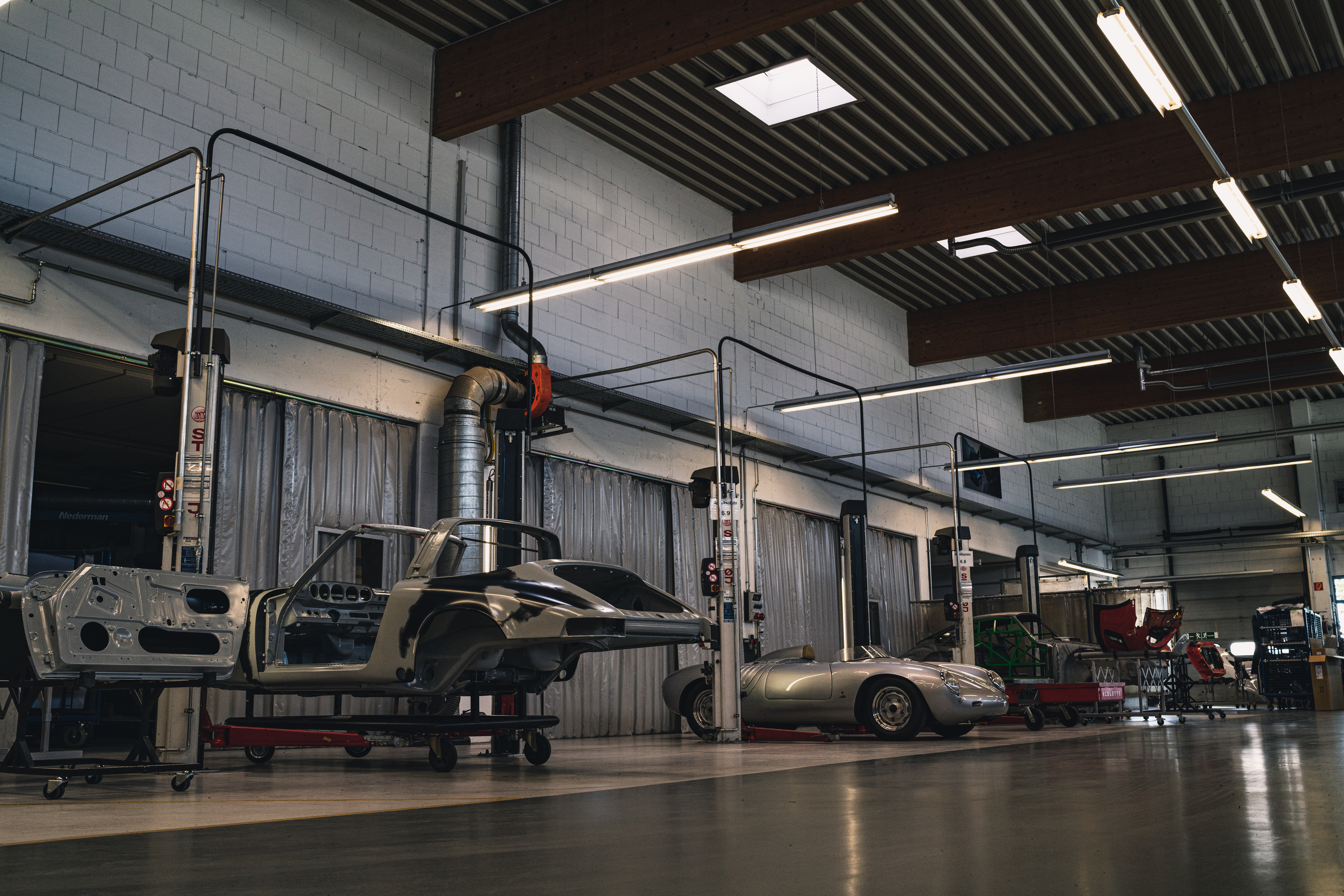 View of Porsche Classic workshop with bays containing cars