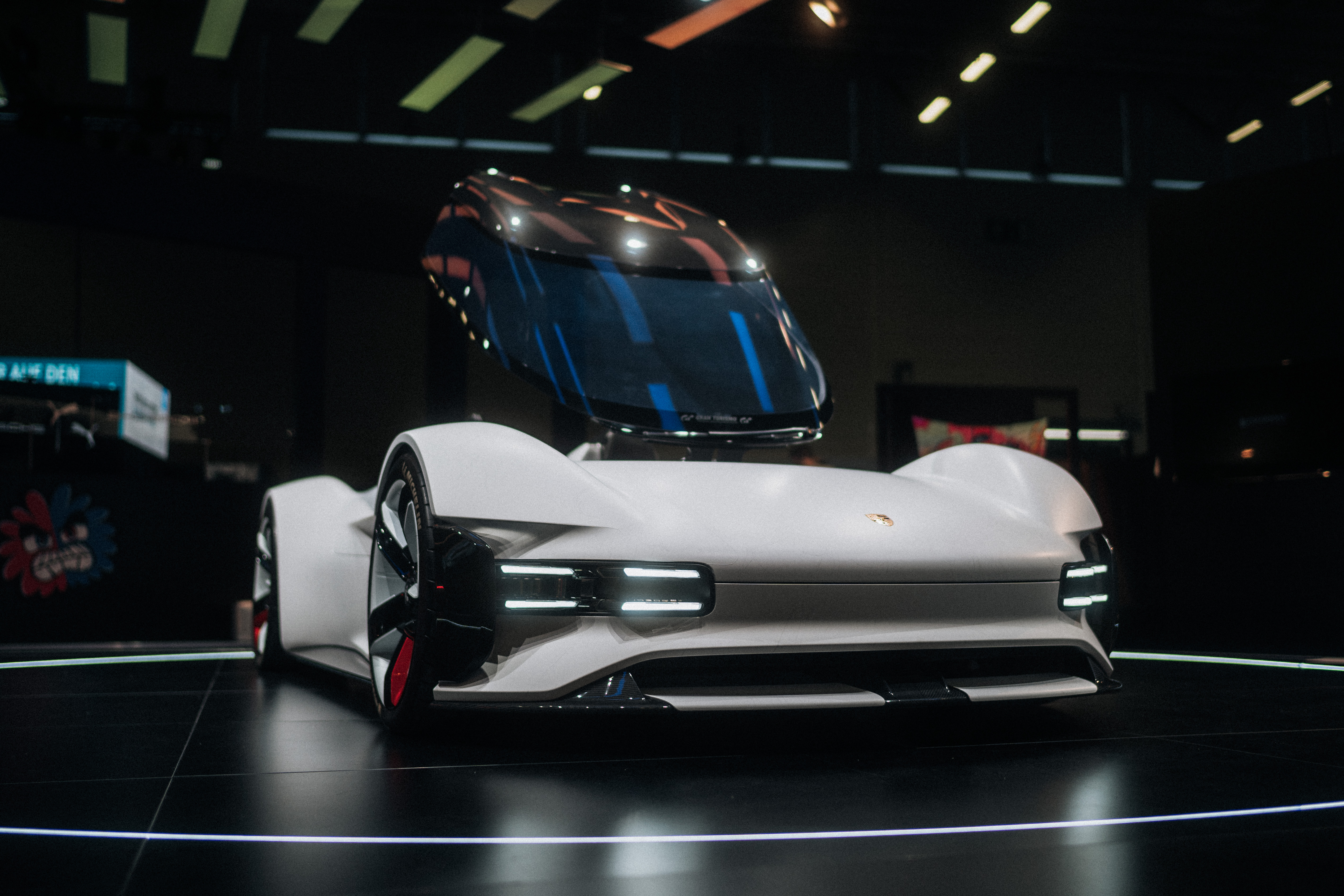 Front view of white Porsche Vision GT, transparent roof raised
