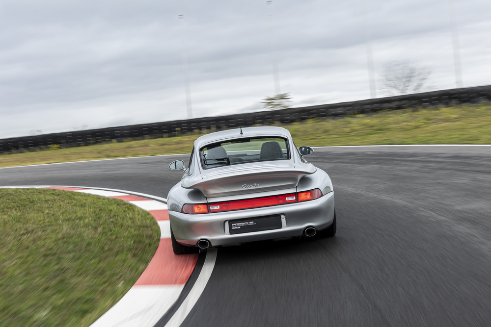Rear view of Porsche 911 Turbo (type 993) driving on track