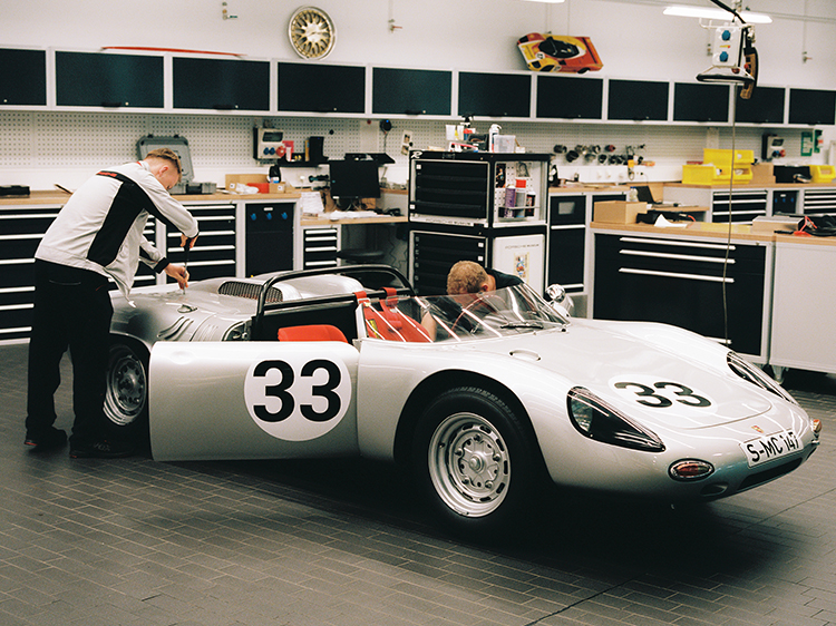 Technicians work on Porsche 718 W-RS Spyder at Porsche Museum