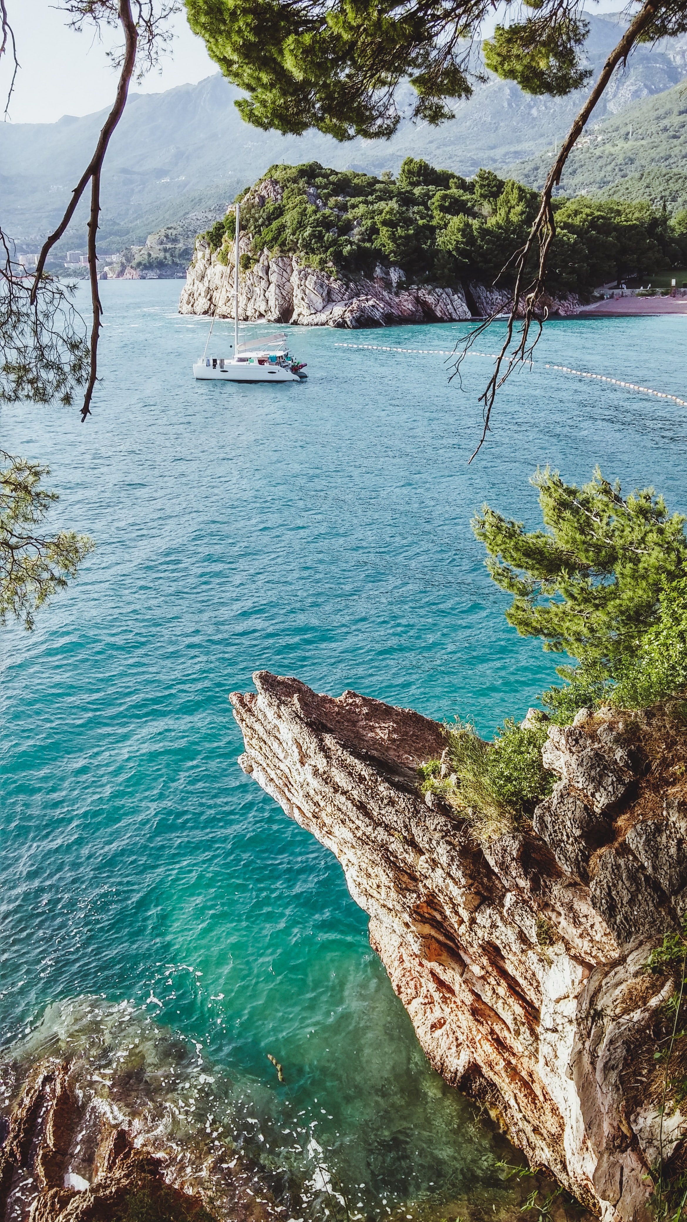 Mediterranean rocky coastline with view of boat