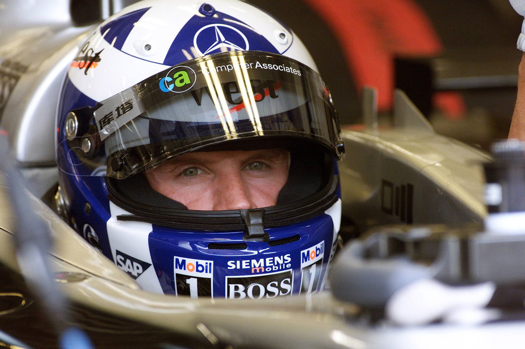 David Coulthard wearing a blue helmet with Saltire cross