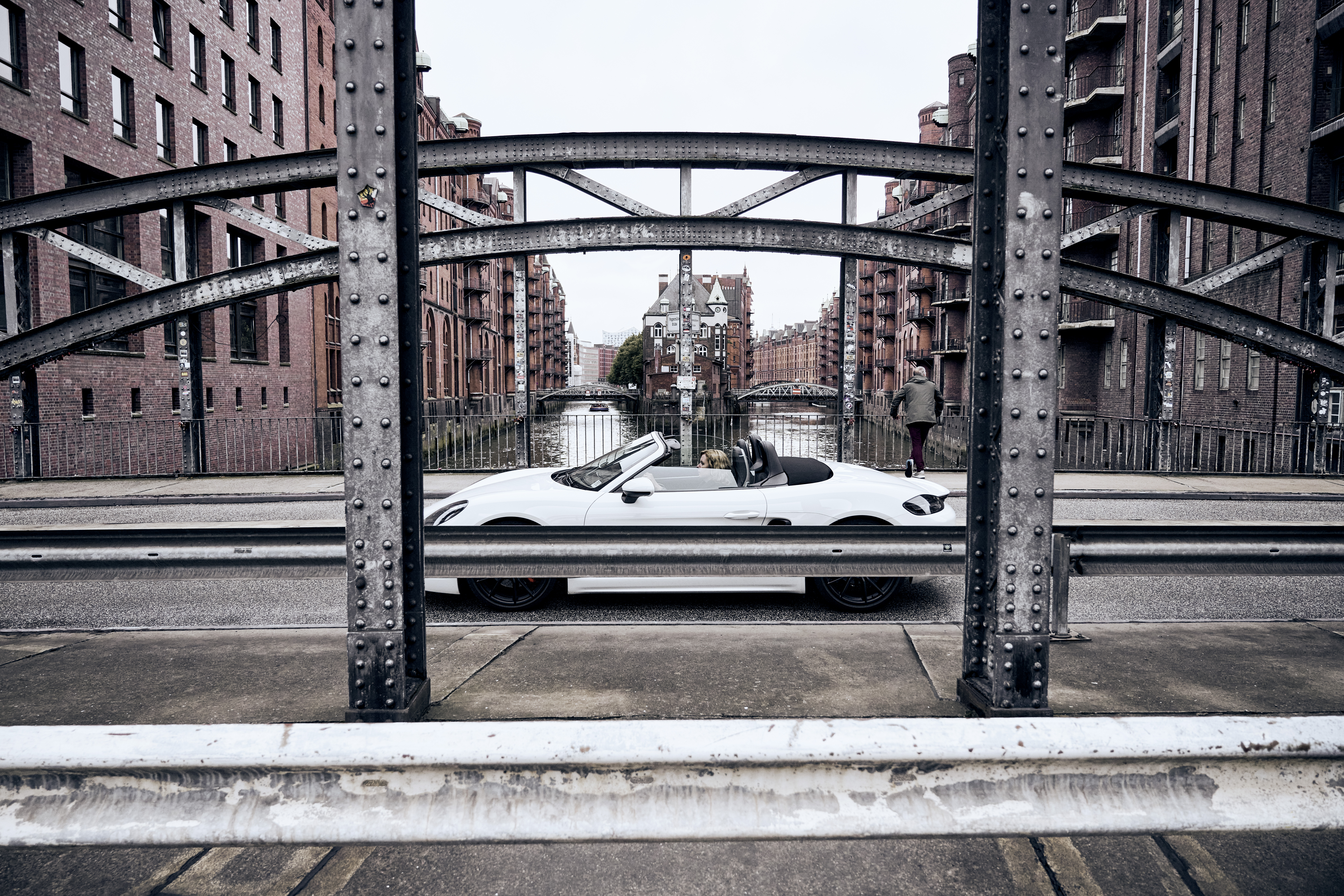 White 718 Boxster passes over bridge in Hamburg’s Speicherstadt district