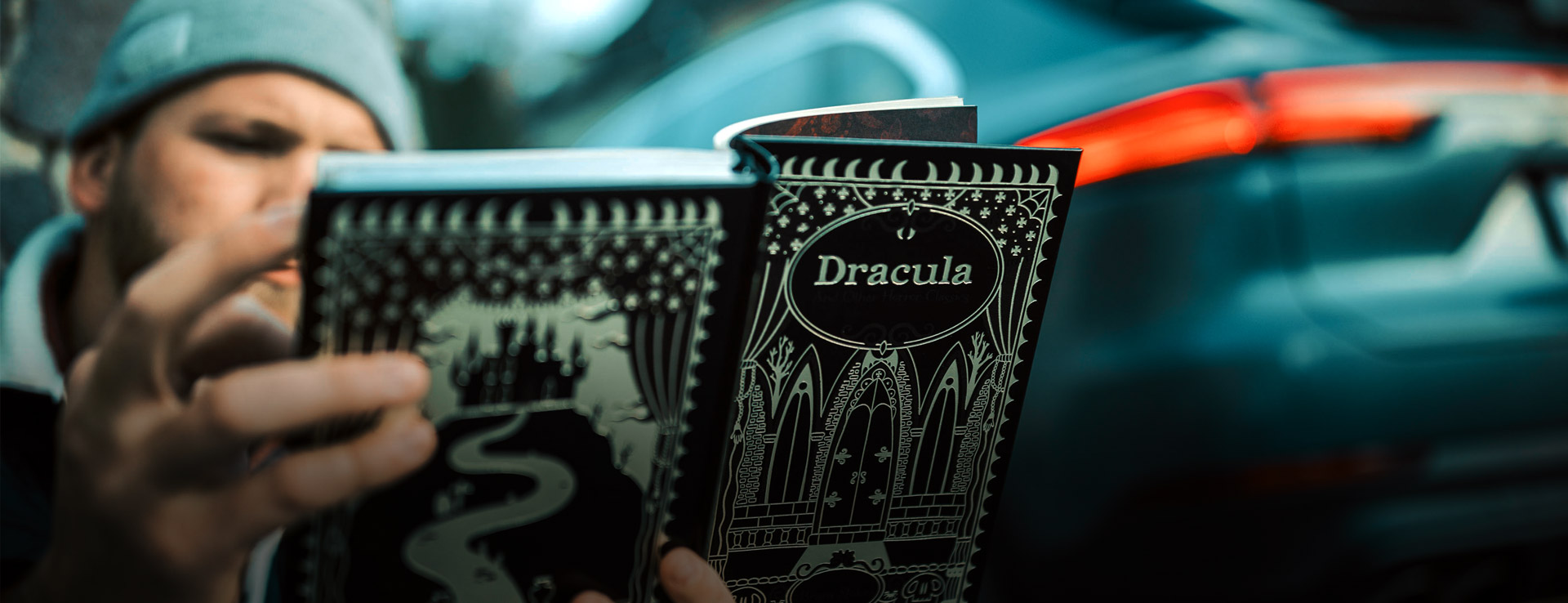 Man reading Dracula Book