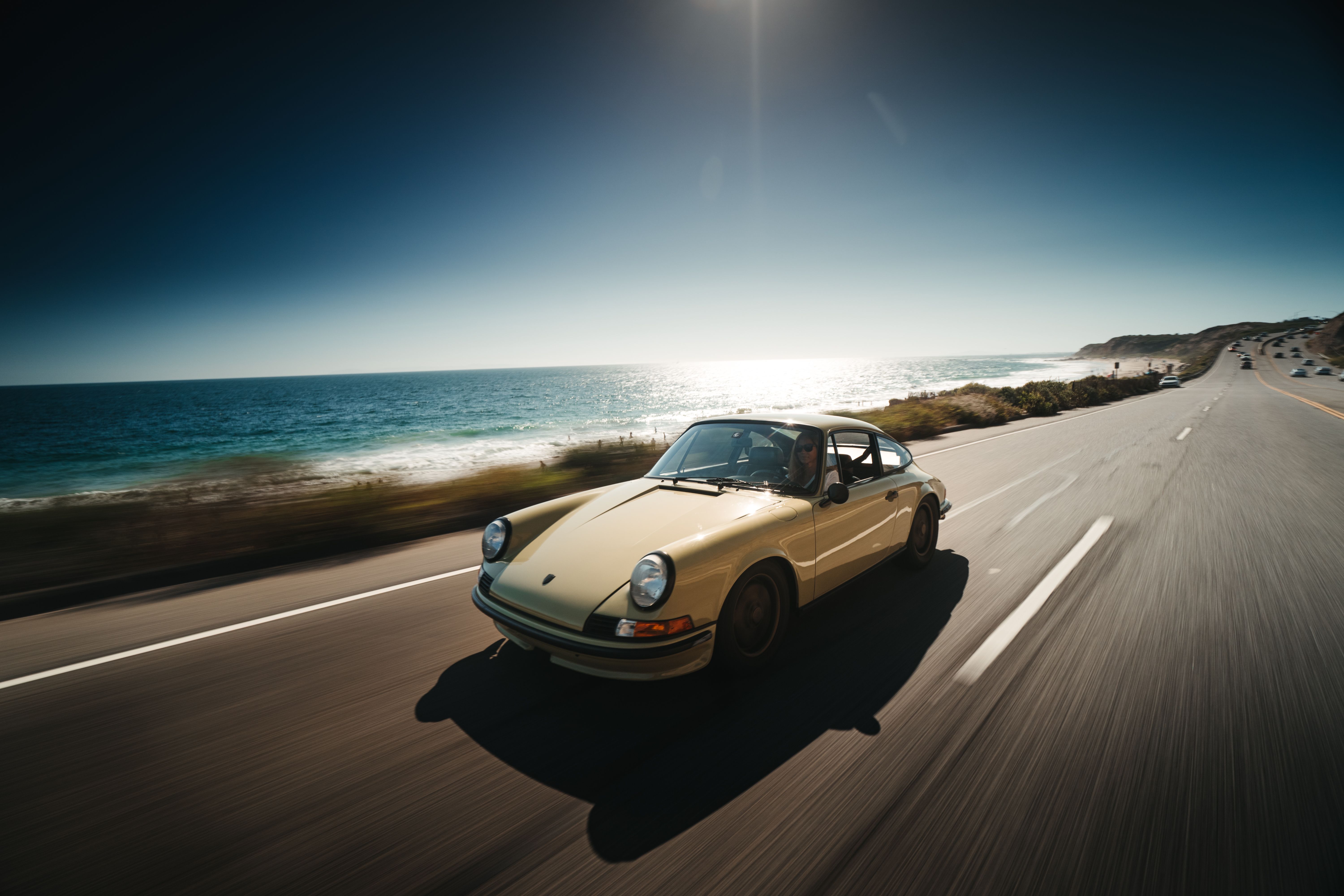 Porsche 911 T drives along sunny Californian coastline
