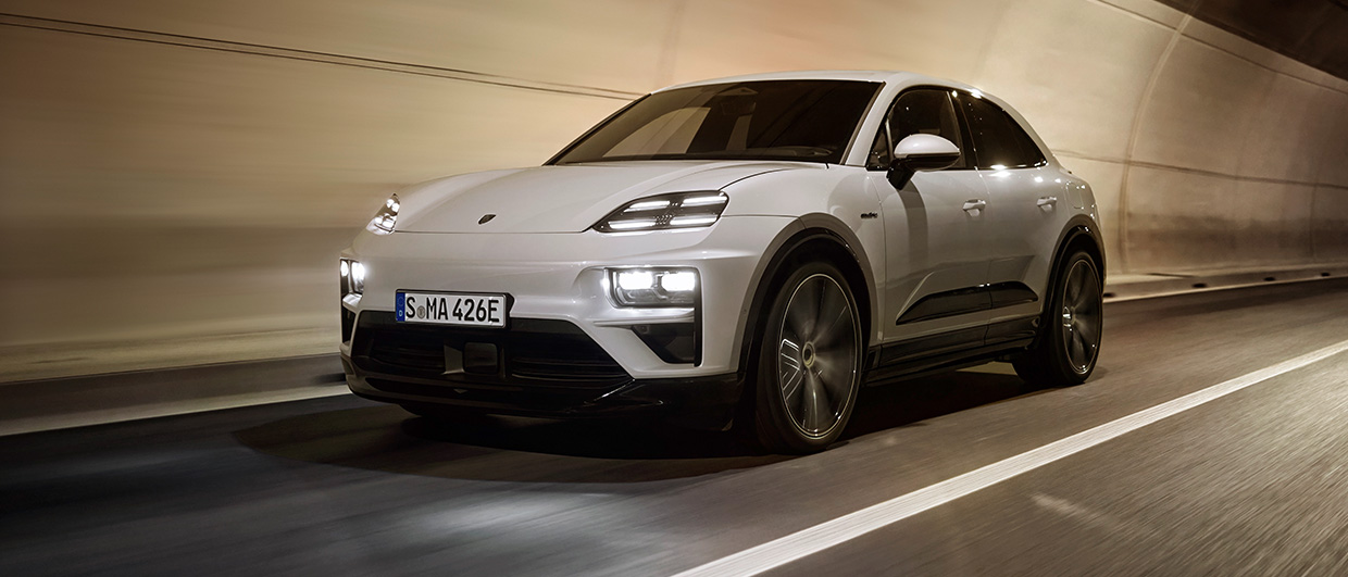 Electric Porsche Macan Turbo in white driving through tunnel