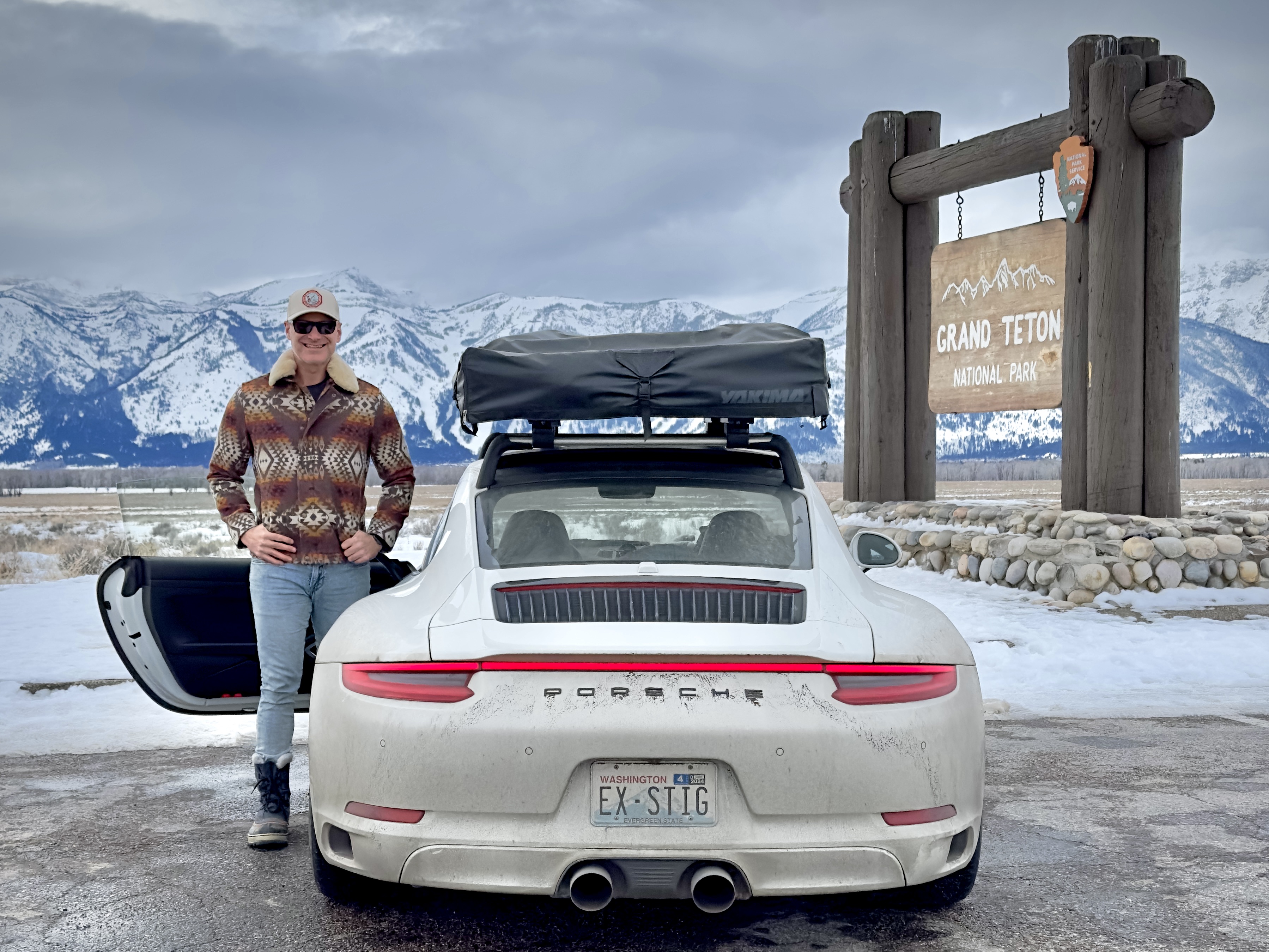 Man beside Porsche 911 Carrera in Grand Teton National Park