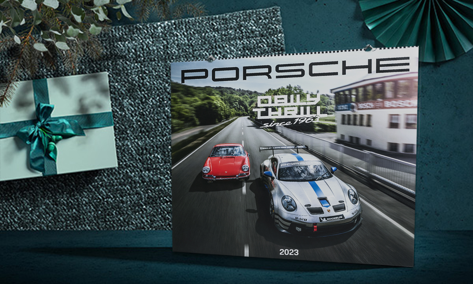 Porsche 2023 calendar lying next to green present