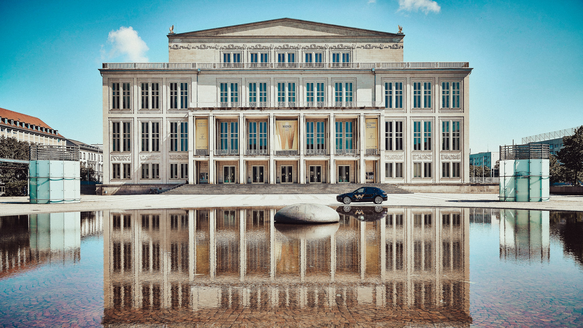 Leipzig Opera House reflected in the water feature outside
