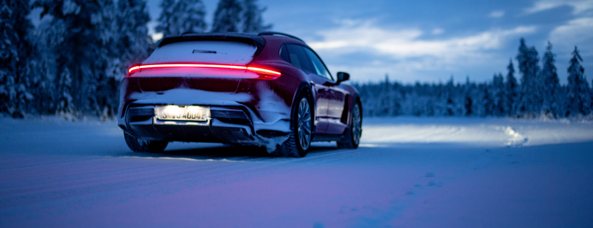 Porsche Taycan Cross Turismo, lights on, at night on snow