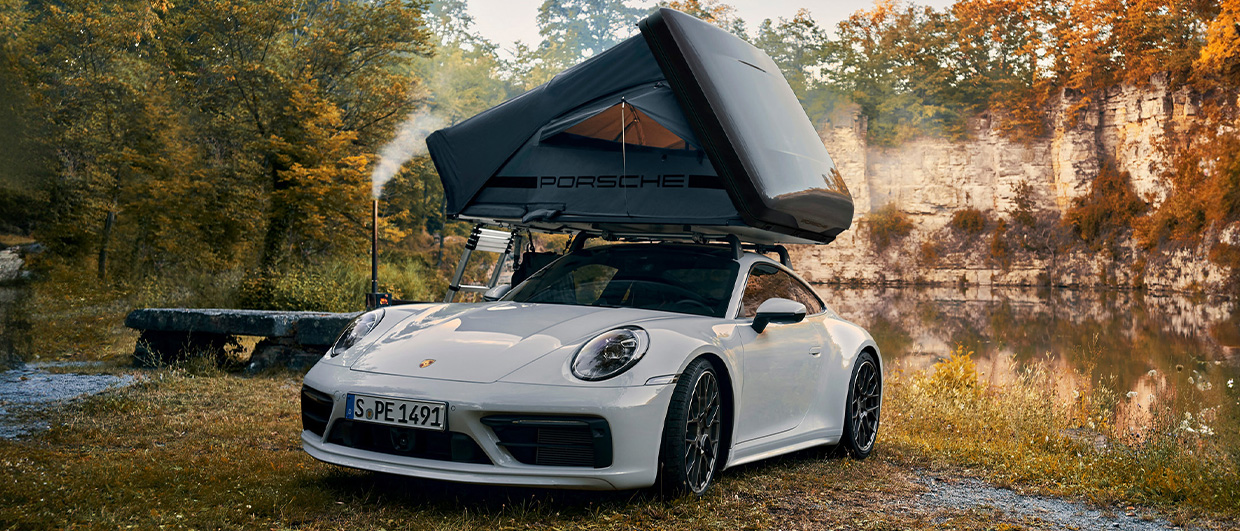White Porsche 911 with roof tent in nature